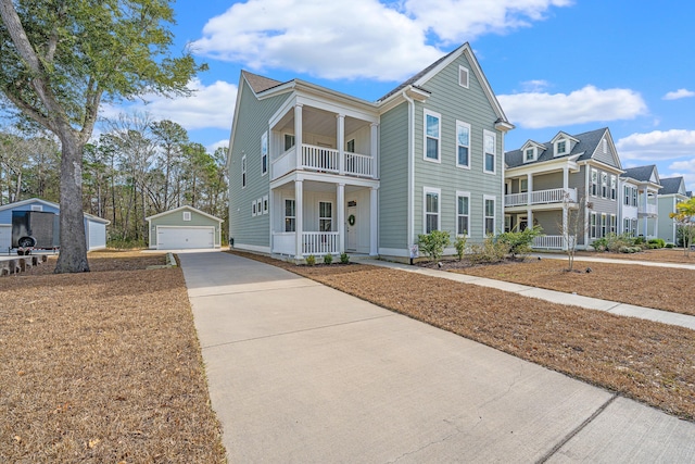 view of front of home with covered porch, an outdoor structure, a balcony, and a garage