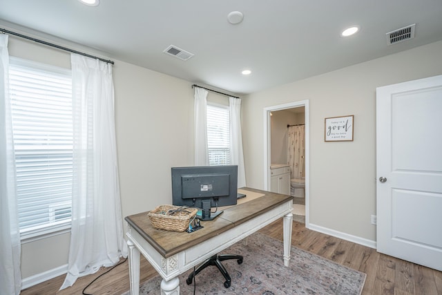 office space with baseboards, recessed lighting, visible vents, and light wood-style floors