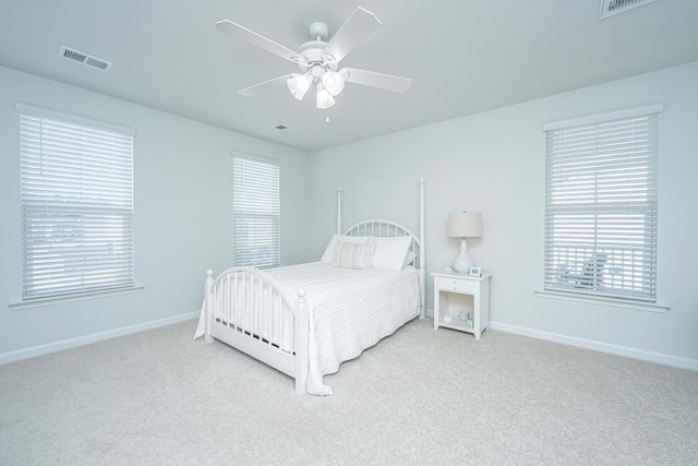 bedroom with carpet floors, visible vents, and baseboards