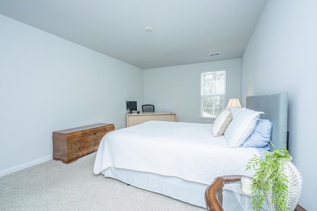 carpeted bedroom featuring baseboards and visible vents