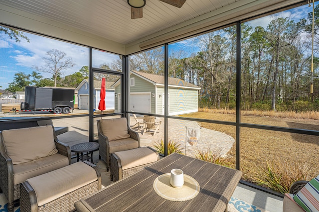 sunroom / solarium featuring ceiling fan