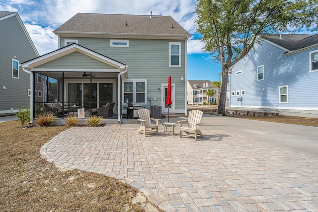 rear view of house with a sunroom, a patio area, and ceiling fan