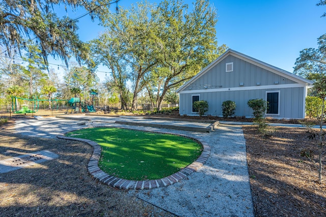 view of yard with a playground and fence