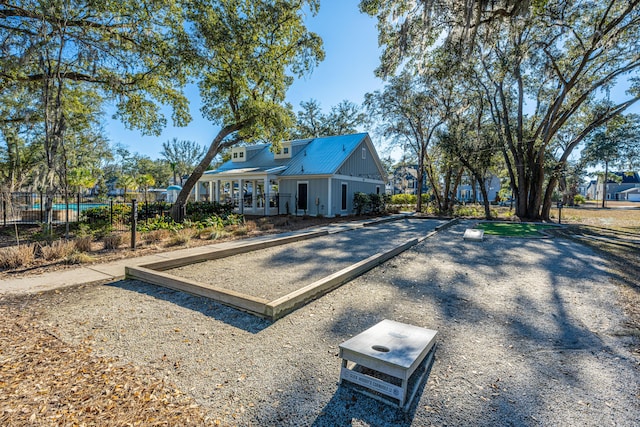 view of front of house with fence and metal roof