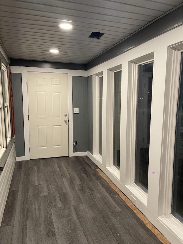 interior space with dark wood-type flooring and wood ceiling