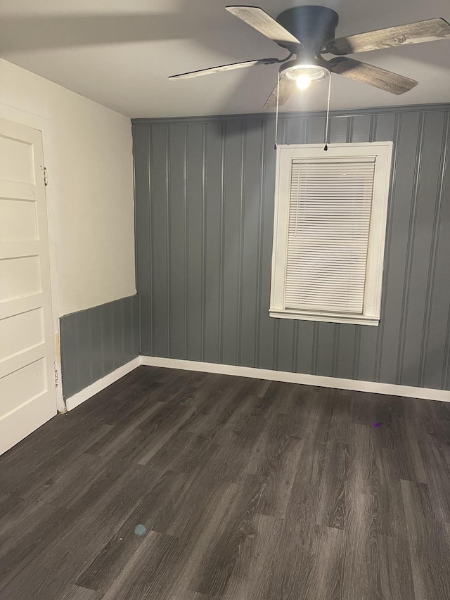 spare room with ceiling fan and dark hardwood / wood-style flooring