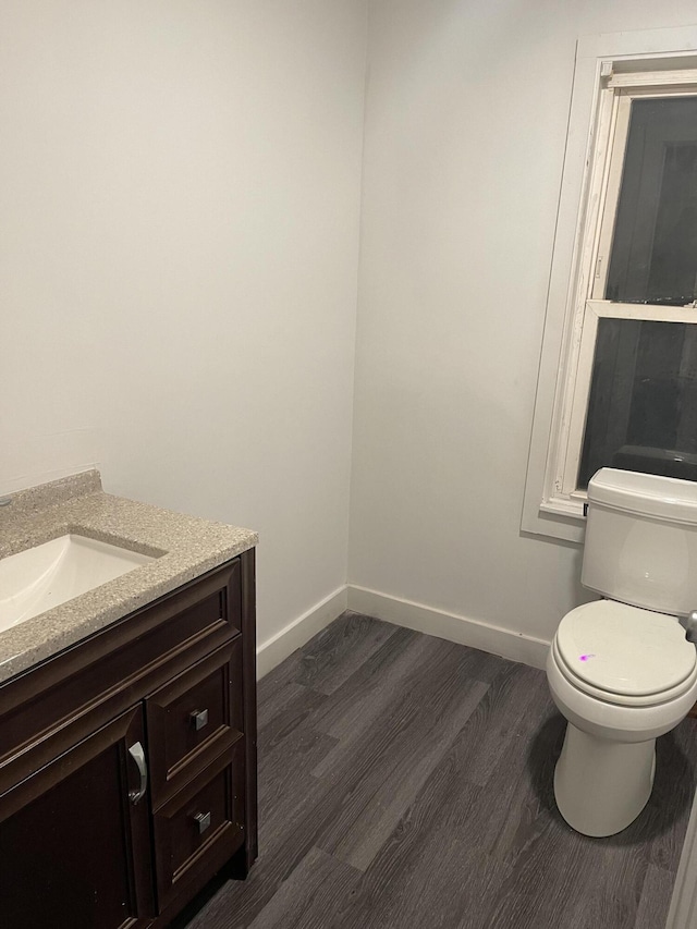 bathroom featuring hardwood / wood-style flooring, vanity, and toilet