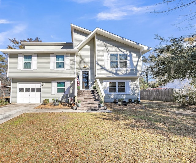 raised ranch with a garage and a front lawn