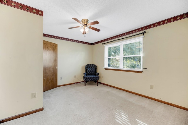 unfurnished room with carpet, a textured ceiling, and ceiling fan