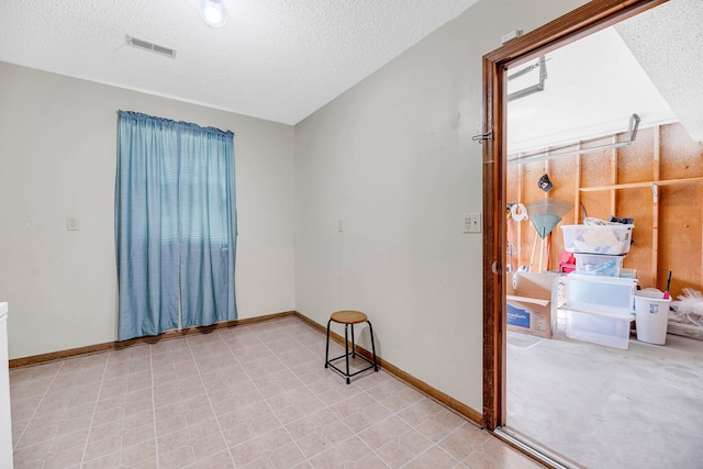 spare room with a textured ceiling