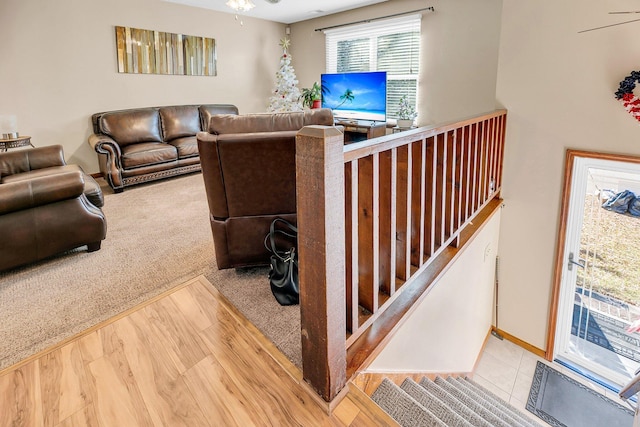 living room with ceiling fan and hardwood / wood-style flooring