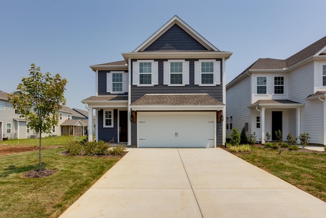 view of front of property featuring a garage and a front yard