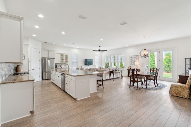 516 Tidewater Chase Ln, Summerville, SC 29486 - kitchen featuring stainless steel appliances, open floor plan, a breakfast bar area, backsplash, and healthy amount of natural light