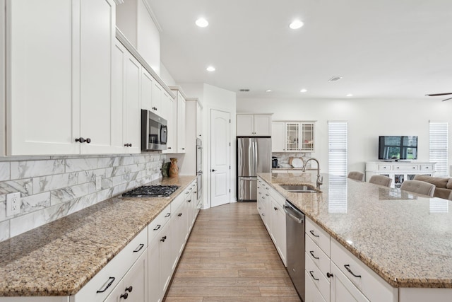 516 Tidewater Chase Ln, Summerville, SC 29486 - kitchen featuring appliances with stainless steel finishes, a sink, open floor plan, a large island with sink, and light wood finished floors