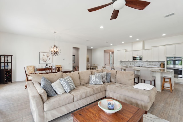 516 Tidewater Chase Ln, Summerville, SC 29486 - living room with light wood-type flooring, ceiling fan, a chandelier, and recessed lighting