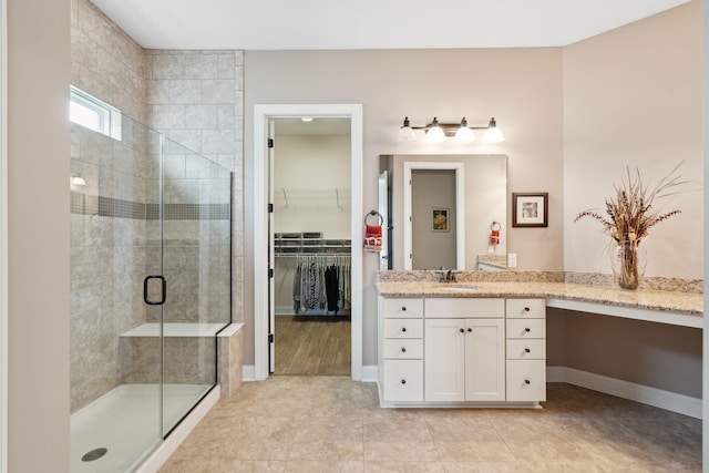 516 Tidewater Chase Ln, Summerville, SC 29486 - bathroom with a shower stall, vanity, a walk in closet, tile patterned floors, and baseboards