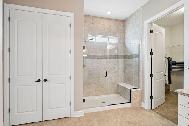 516 Tidewater Chase Ln, Summerville, SC 29486 - bathroom with a shower stall, baseboards, a walk in closet, vanity, and tile patterned flooring