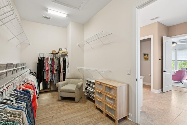 516 Tidewater Chase Ln, Summerville, SC 29486 - walk in closet with attic access, light wood-style floors, and ceiling fan