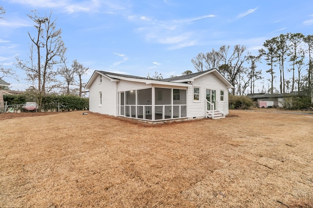 rear view of property with a yard and a sunroom