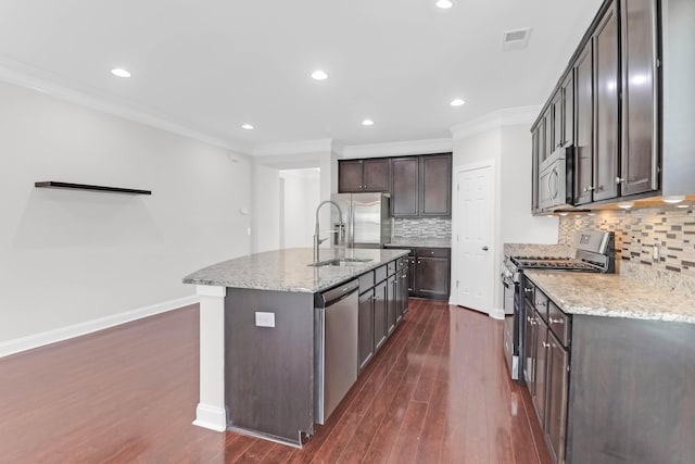 kitchen with visible vents, appliances with stainless steel finishes, ornamental molding, a sink, and dark brown cabinets