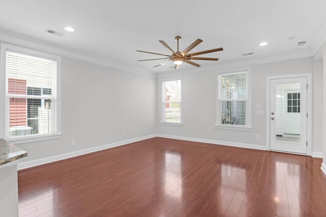 unfurnished living room featuring visible vents, crown molding, and wood finished floors