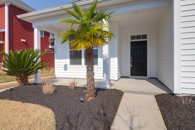 view of exterior entry featuring a porch