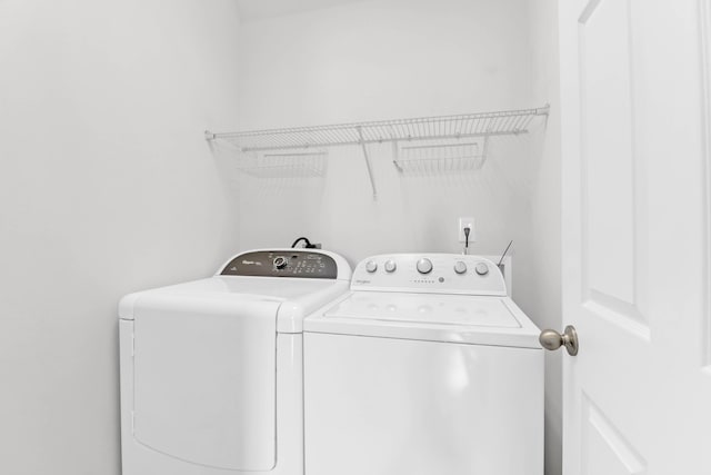 washroom featuring washing machine and dryer and laundry area