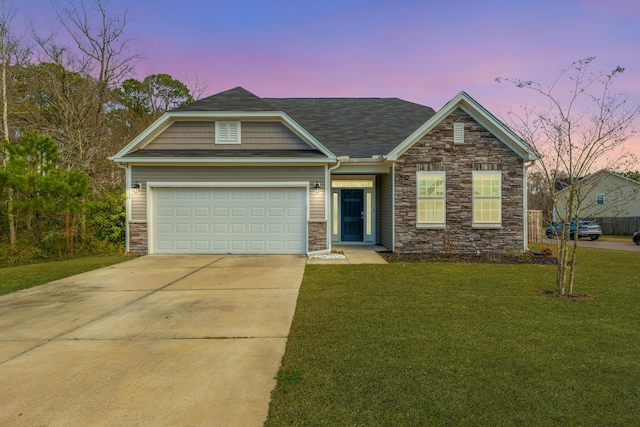 craftsman-style house featuring a garage, a lawn, and driveway