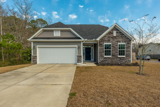 craftsman house featuring an attached garage, concrete driveway, and a front yard