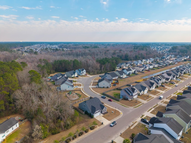 aerial view featuring a residential view and a wooded view