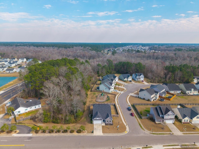 birds eye view of property featuring a wooded view and a residential view