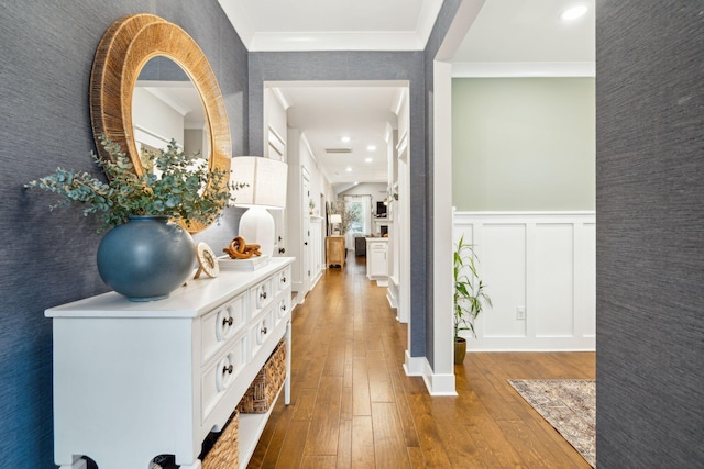 hallway with wood-type flooring and ornamental molding