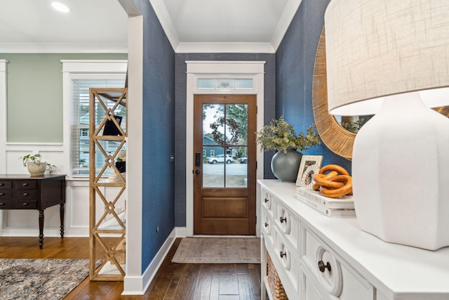 foyer entrance with crown molding and dark hardwood / wood-style flooring