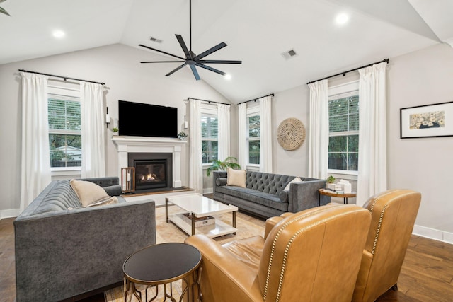 living room with dark hardwood / wood-style floors, a healthy amount of sunlight, and lofted ceiling