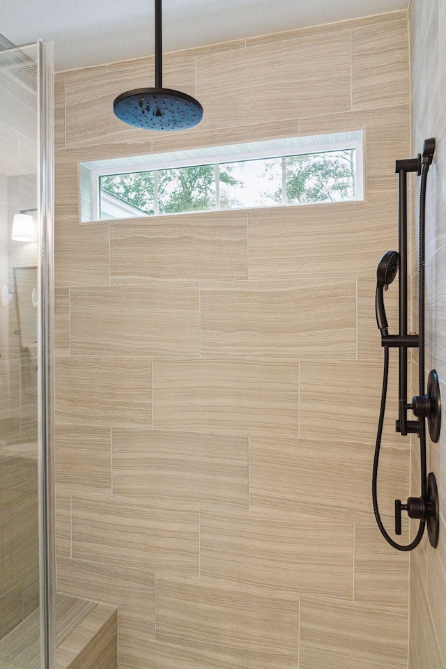 bathroom with tiled shower