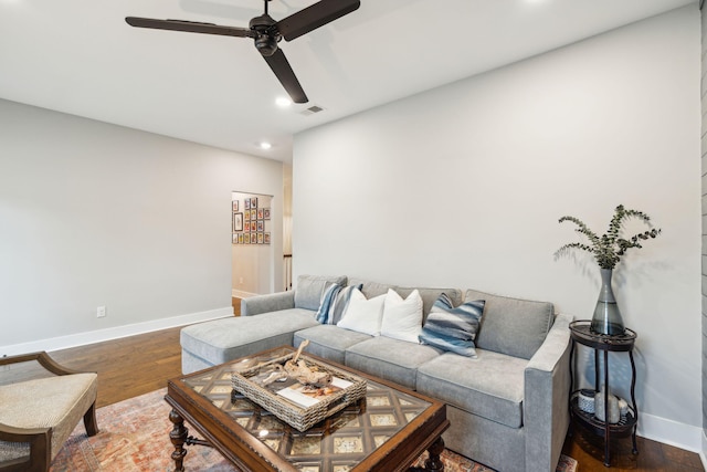 living room with ceiling fan and dark hardwood / wood-style floors