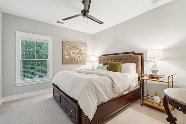 bedroom with ceiling fan and light colored carpet