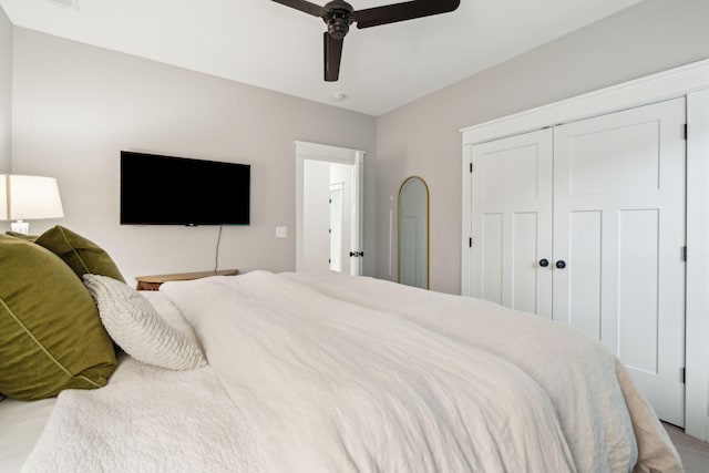 bedroom with ceiling fan and a closet