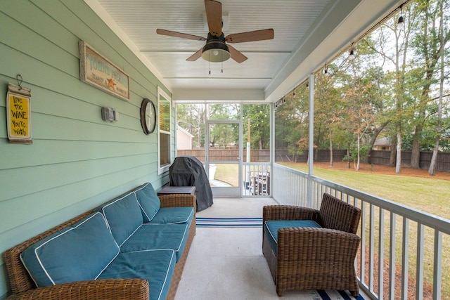 sunroom featuring ceiling fan