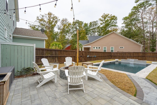 view of patio / terrace with a fenced in pool and an outdoor fire pit