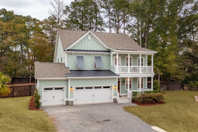 view of front of house featuring a balcony, a front lawn, covered porch, and a garage