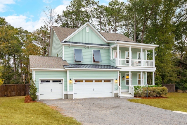 view of front of home with a front yard, a garage, and covered porch