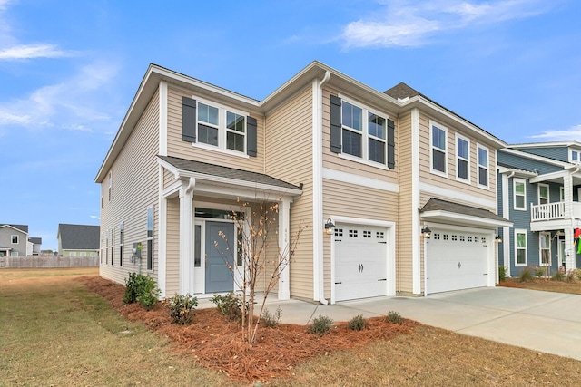 view of front of house with a garage, driveway, and a front lawn