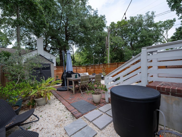 2 Live Oak Ave, Charleston, SC 29407 - view of patio / terrace featuring a fenced backyard, an outdoor structure, and outdoor dining area
