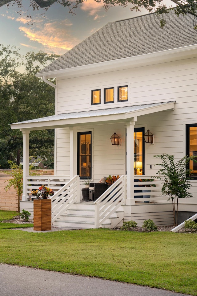 2 Live Oak Ave, Charleston, SC 29407 - modern farmhouse style home with roof with shingles, a front lawn, and covered porch