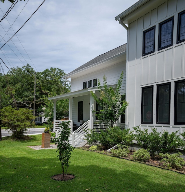 2 Live Oak Ave, Charleston, SC 29407 - exterior space featuring board and batten siding, a porch, and a lawn