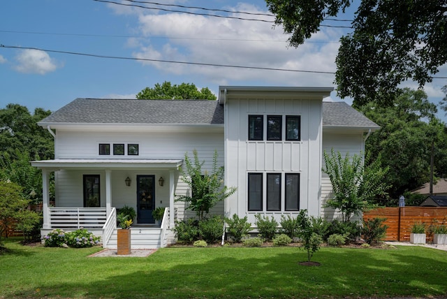 2 Live Oak Ave, Charleston, SC 29407 - modern farmhouse featuring board and batten siding, covered porch, a front yard, fence, and a shingled roof