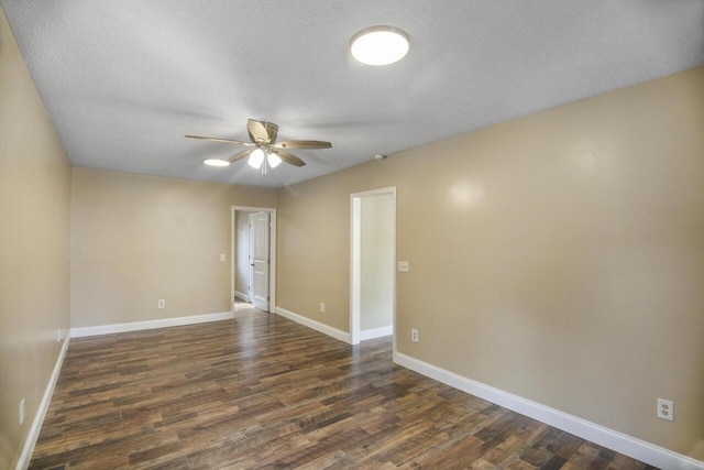 spare room featuring dark hardwood / wood-style flooring, ceiling fan, and a textured ceiling