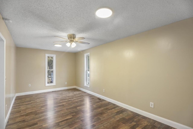 spare room featuring a textured ceiling, ceiling fan, and dark wood-type flooring