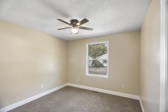 carpeted empty room with ceiling fan and a textured ceiling